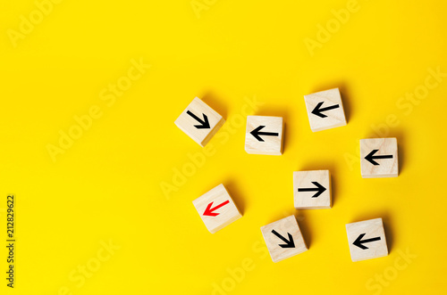 Φωτογραφία Wooden blocks with red arrow facing the opposite direction black arrows, Unique, dissenting opinion, individual and standing out from the crowd