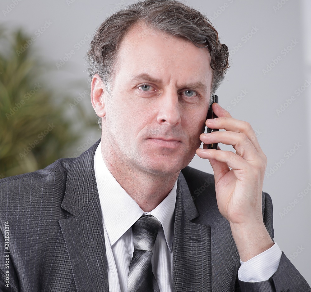 Businessman having phone call conversation at workplace Businessman having phone call conversation at workplace