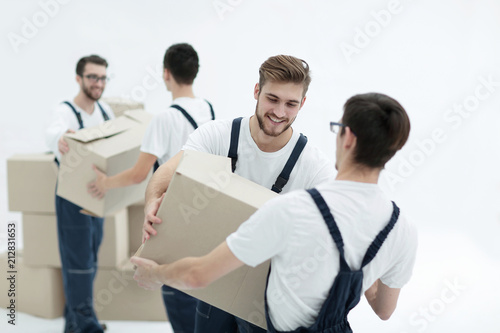 Portrait of movers holding box smiling isolated on white backgro