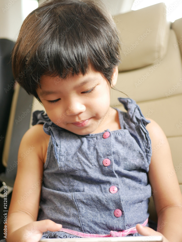 Little Asian baby girl's, 30 months old, holding and using a mobile phone Little Asian baby girl's, 30 months old, holding and using a mobile phone