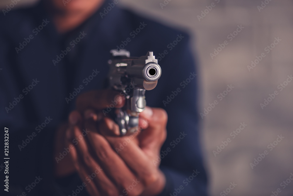 Mafia man holding a gun to intimidate Mafia man holding a gun to intimidate
