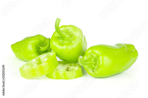 Group of three whole two slices of light green bell pepper isolated on white. photo