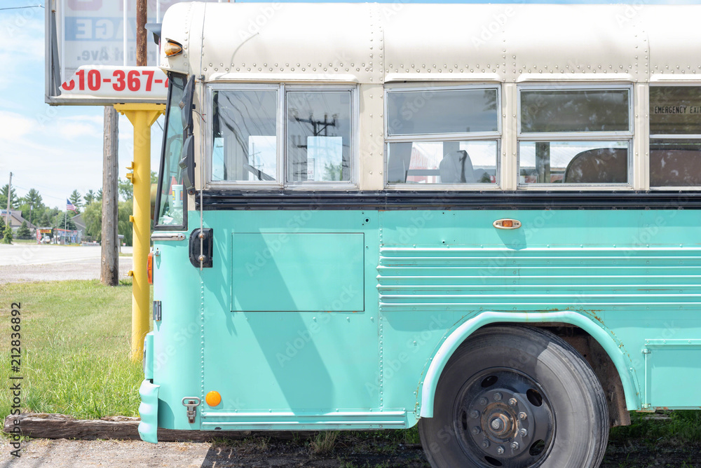 Retro school bus painted turquoise ready for an epic road trip