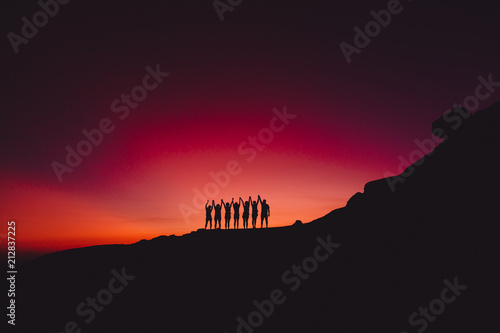 Bright sunset or sunrise and silhouette of people