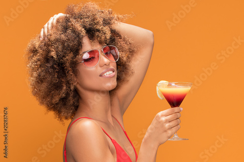 Photography Afro girl having fun with colorful drink.