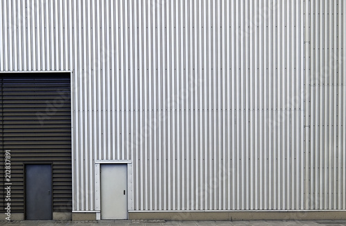 Metallic wall with striped line texture with closed doors.