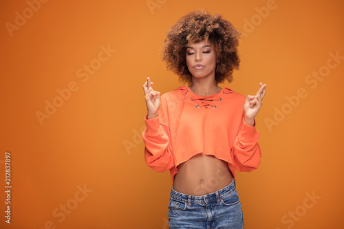 Young afro girl doing meditation gesture.