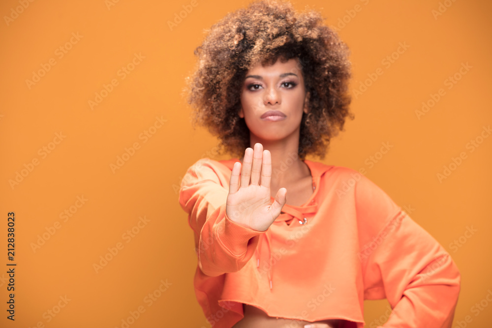 Afro girl making stop sign with hand. Afro girl making stop sign with hand.