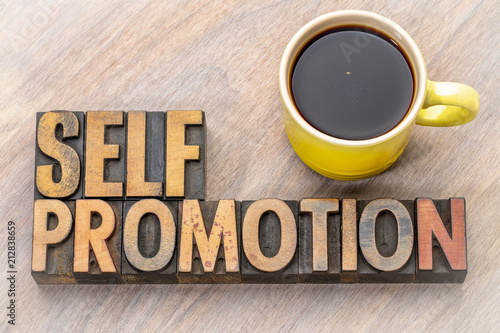 self promotion - word abstract in wood type
