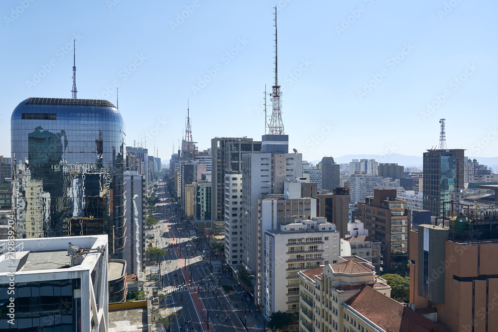 Fototapeta premium Paulista avenue in Sao Paulo. Aerial view of most famous avenue of Sao Paulo on national holiday morning on a sunny day. Important financial and business center of Brazil.