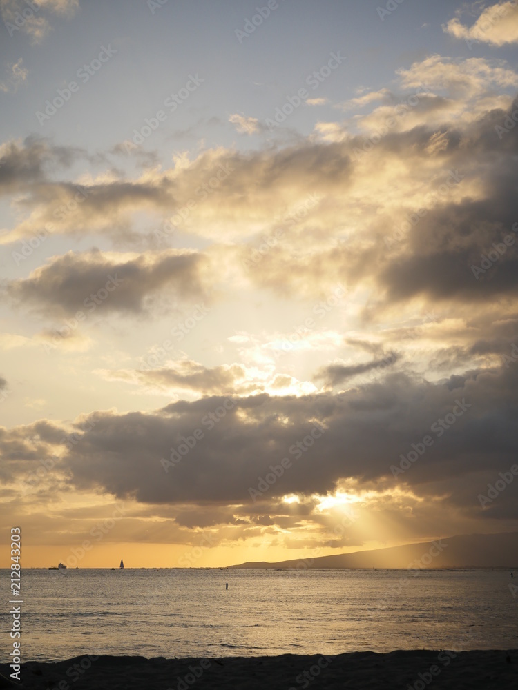 sunset sunshine rays coming out of clouds during sunset hawaii waikiki