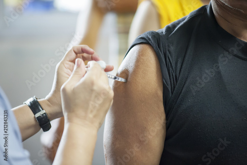 Patients received vaccines from doctors to prevent the disease. Medical concept