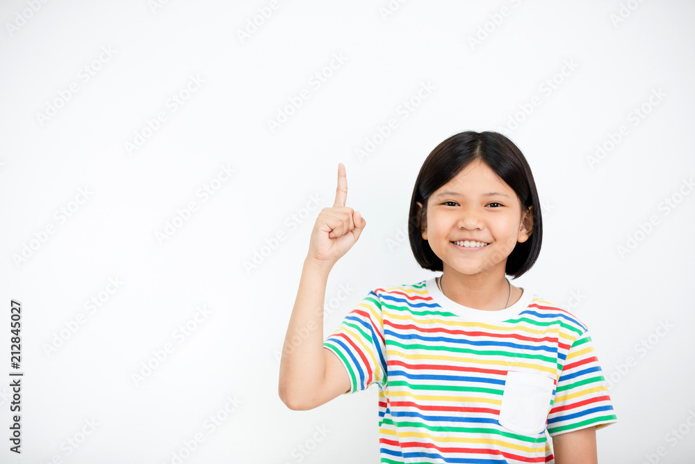 Asian girl smiling and pointing finger up . Asian girl smiling and pointing finger up .
