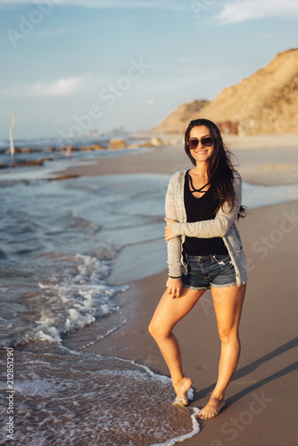 Young beautiful girl posing by the sea