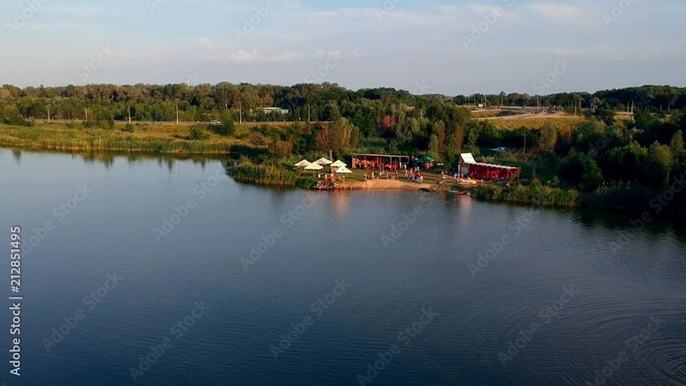 POLTAVA, UKRAINE - JUNE 18, 2016: people have a happy time in park near lake POLTAVA, UKRAINE - JUNE 18, 2016: people have a happy time in park near lake
