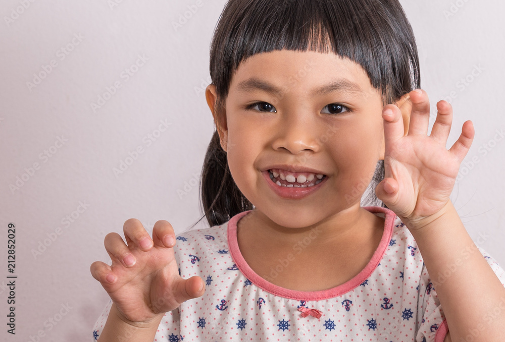 little girl in funny moment, playing and acting as monster little girl in funny moment, playing and acting as monster