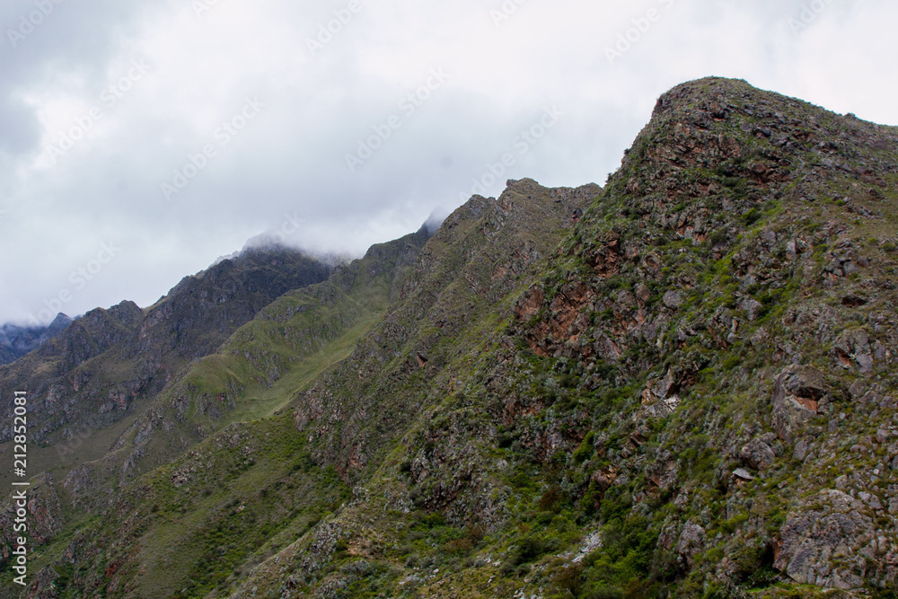 Beautiful background image of the wild nature of the Andes mountains and clouds along the Inca Trail. Peru. South America. No people. Beautiful background image of the wild nature of the Andes mountains and clouds along the Inca Trail. Peru. South America. No people.