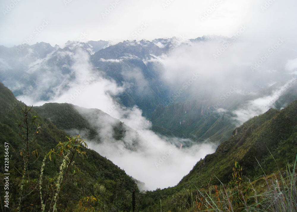 Panoramic view from the Inca Trail of the Sacred Valley with intense low clouds on the Andes mountains. Peru. South America. No people.