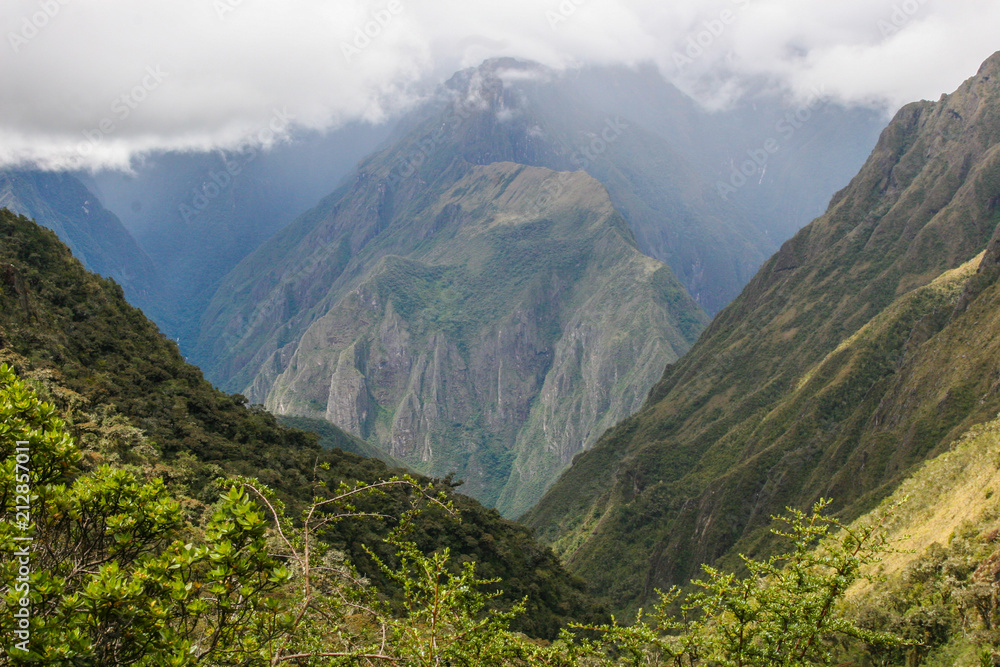 Beautiful background image of the wild nature of the Andes mountains and clouds along the Inca Trail. Peru. South America. No people. Beautiful background image of the wild nature of the Andes mountains and clouds along the Inca Trail. Peru. South America. No people.