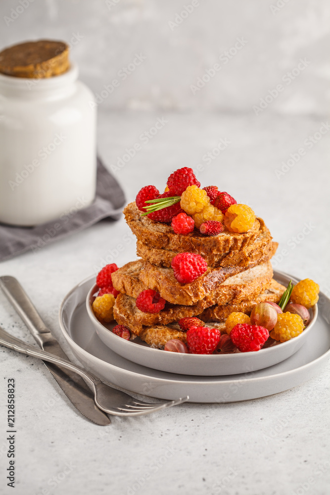 French toast with berries and syrup, vertical. Healthy vegan food concept. French toast with berries and syrup, vertical. Healthy vegan food concept.