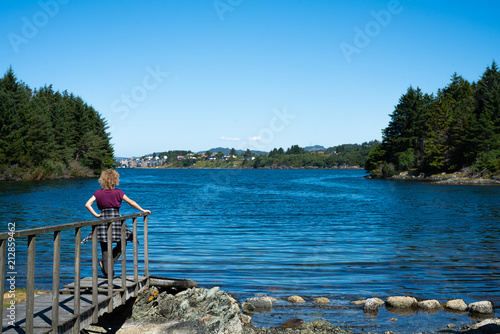 Girl watching over a lake in norway near haugesund photo