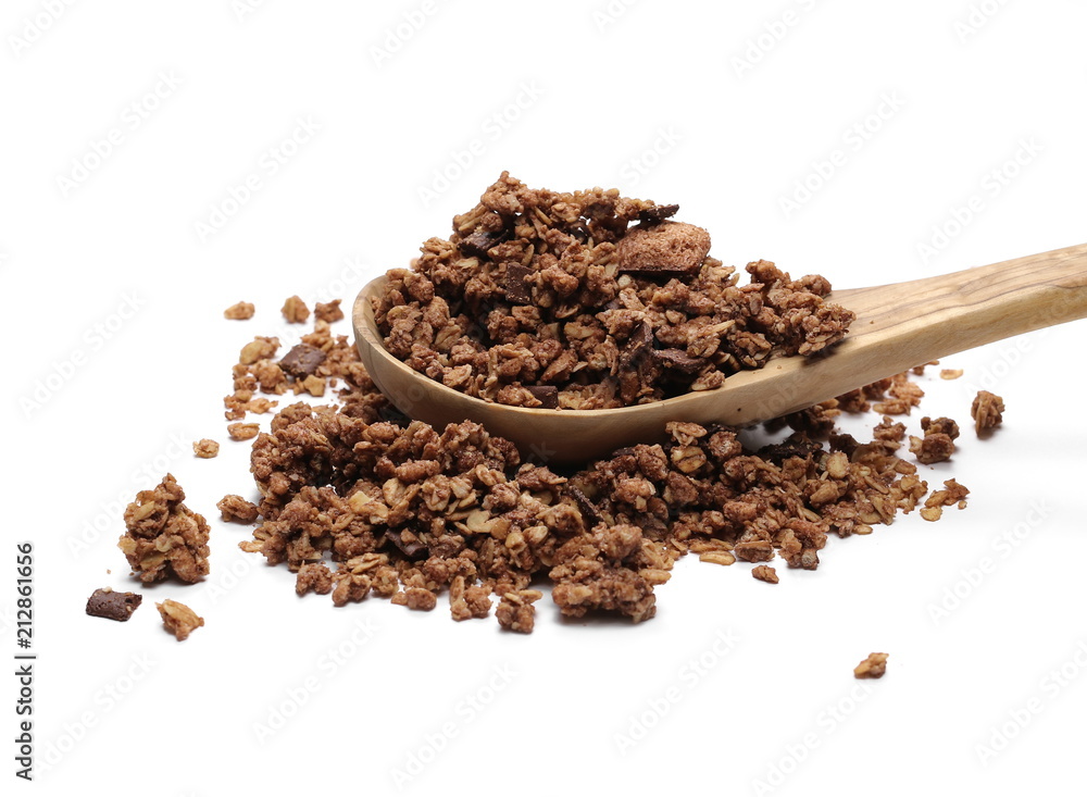 Crunchy chocolate granola, muesli pile with wooden spoon isolated on white background Crunchy chocolate granola, muesli pile with wooden spoon isolated on white background