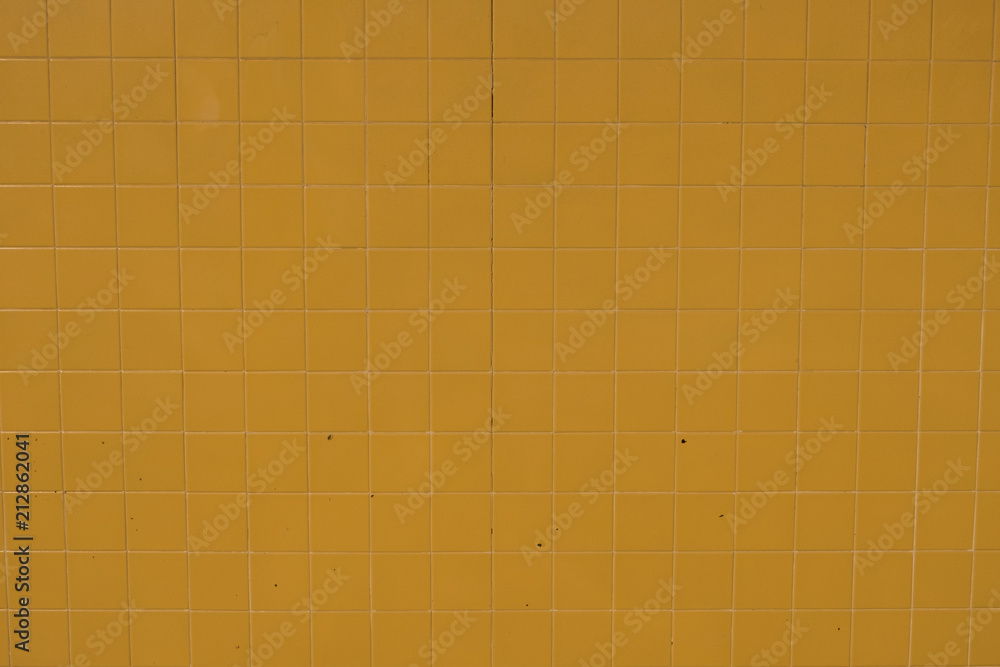 Wall surface made of yellow tiles. Wallpaper image of textures. Wall surface made of yellow tiles. Wallpaper image of textures.