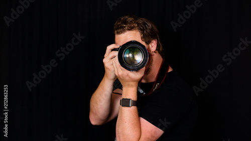 A photographer holds his camera