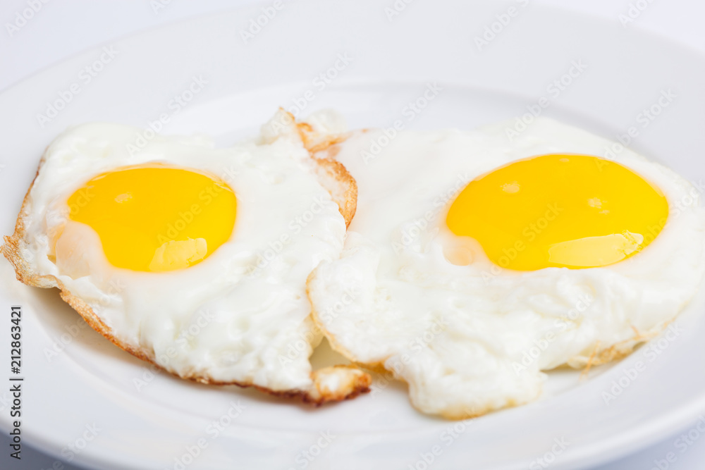 A beautiful photo of a closeup menu of fresh delicious eggs on a plate on a white background A beautiful photo of a closeup menu of fresh delicious eggs on a plate on a white background