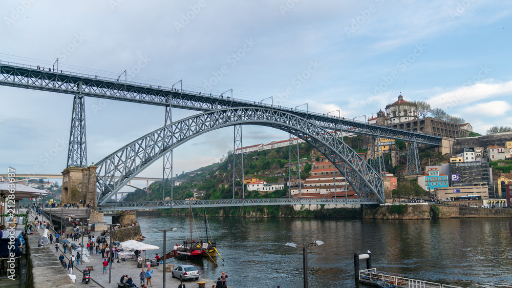 View of the famous Dom Luiz bridge in Porto, Portugal on a cloudy day
