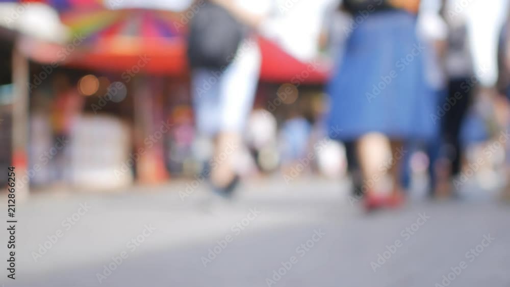Anonymous crowd of people walking on Jatujak weekend market, Out of focus background from busy big city with people crossing street. Bangkok, Thailand Anonymous crowd of people walking on Jatujak weekend market, Out of focus background from busy big city with people crossing street. Bangkok, Thailand