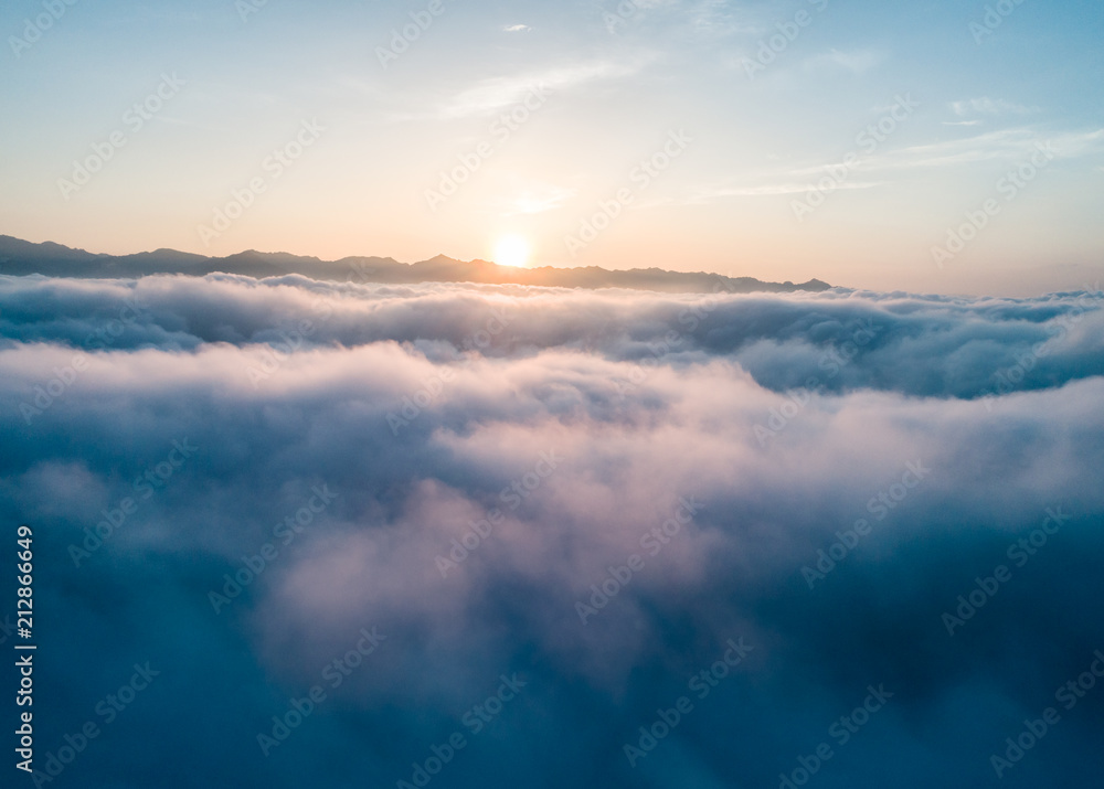 Beautiful Flying over the Clouds with the evening (morning) Sun.