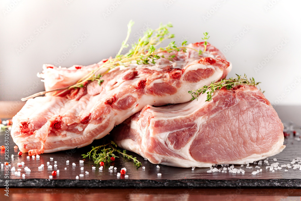 The carcass of a pig is divided into parts, an edge, a fillet, a scapula, a neck, a notch, a ham, a ham, a back. With spices, marasm. honest, pepper and salt. Raw pork meat. background image.