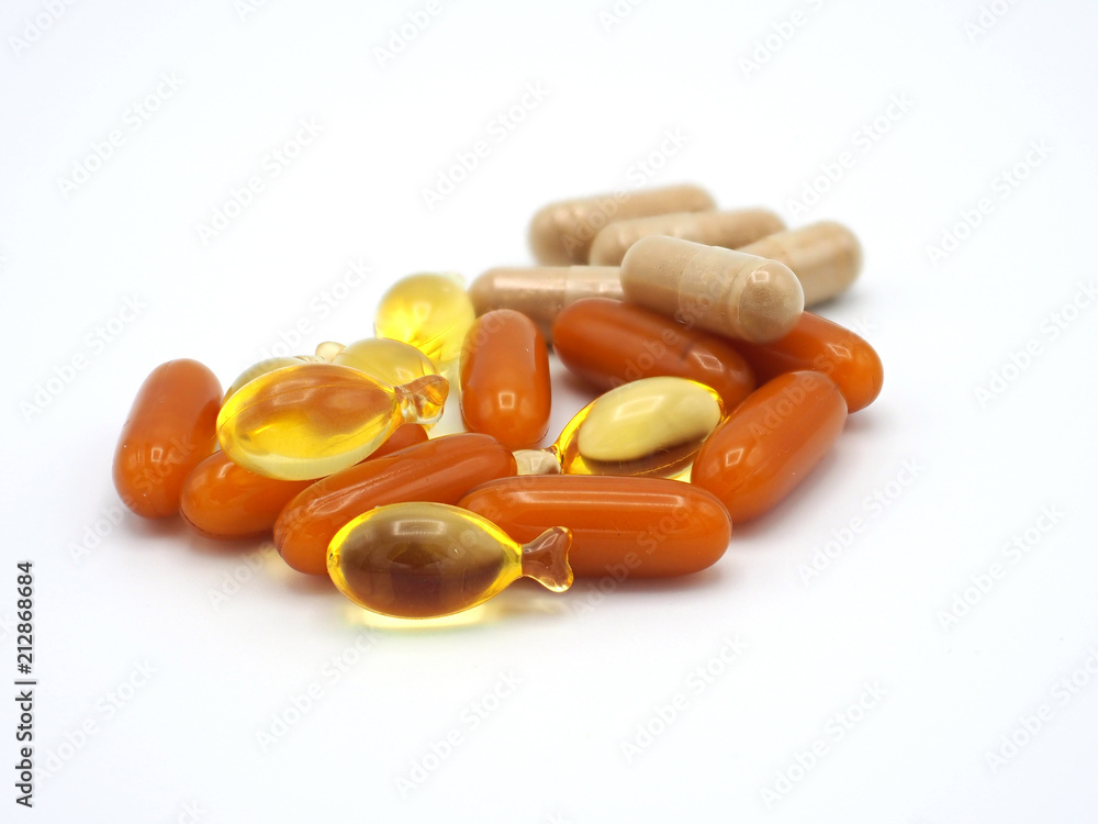 Colorful medicines in capsule and fish shape in white background. Colorful medicines in capsule and fish shape in white background.