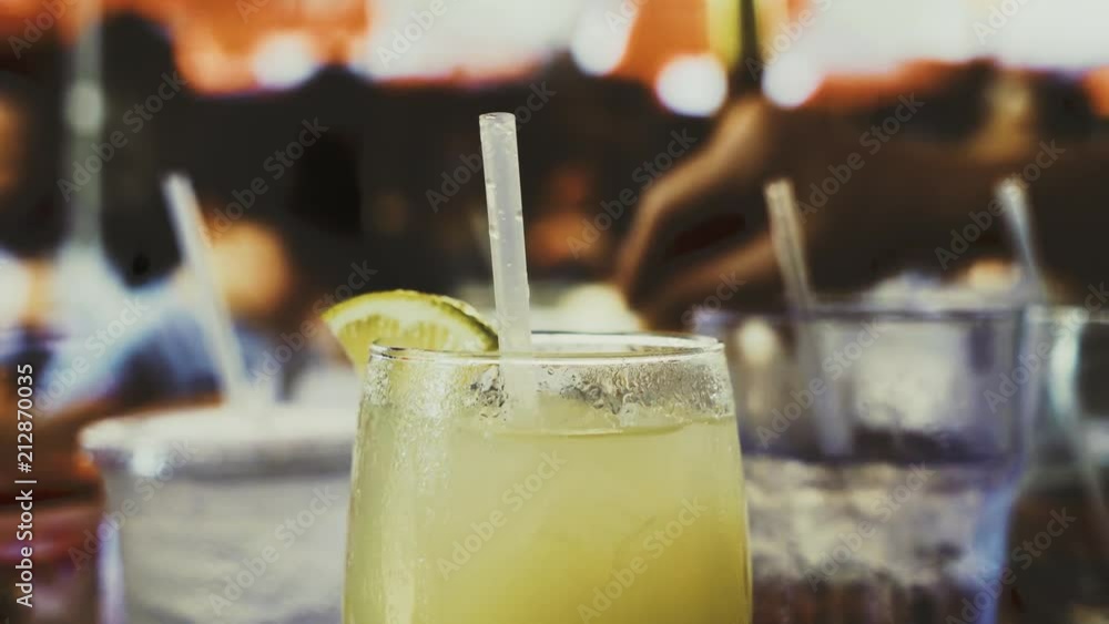 Margarita on a table on an outside patio while people are eating dinner. Margarita on a table on an outside patio while people are eating dinner.