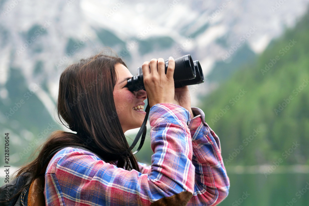 Portrait of a beautiful woman (girl) while she is looking at the mountains. Concept: Holiday, travel, happiness, freedom