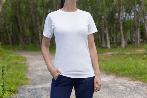Cropped image of young hipster girl wearing blank white t-shirt and black jeans, mock-up of blank white t-shirt