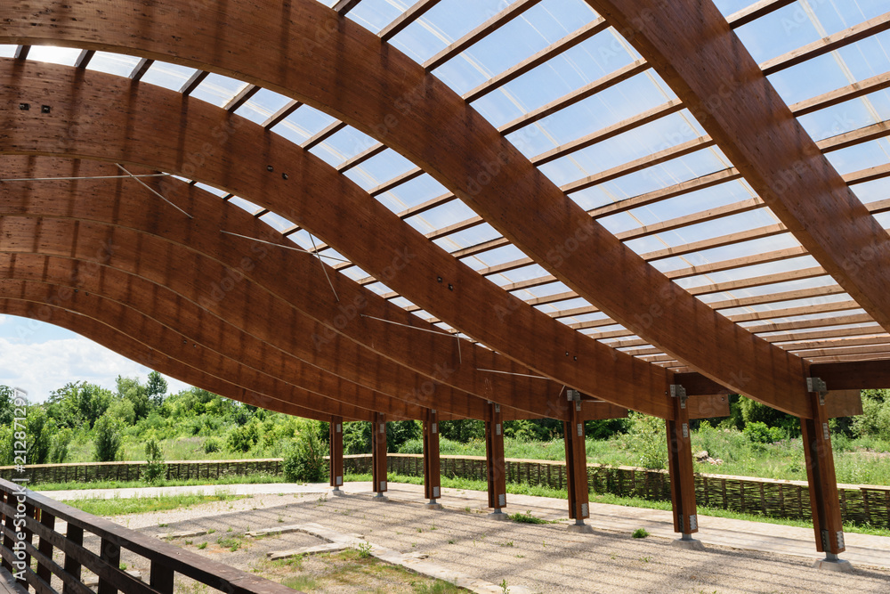 massive wood beams roof structure with S curved shaped and covered with