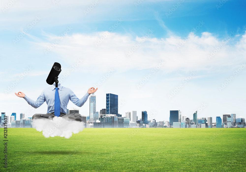 Camera headed man sitting in lotus pose on cloud against modern cityscape Camera headed man sitting in lotus pose on cloud against modern cityscape