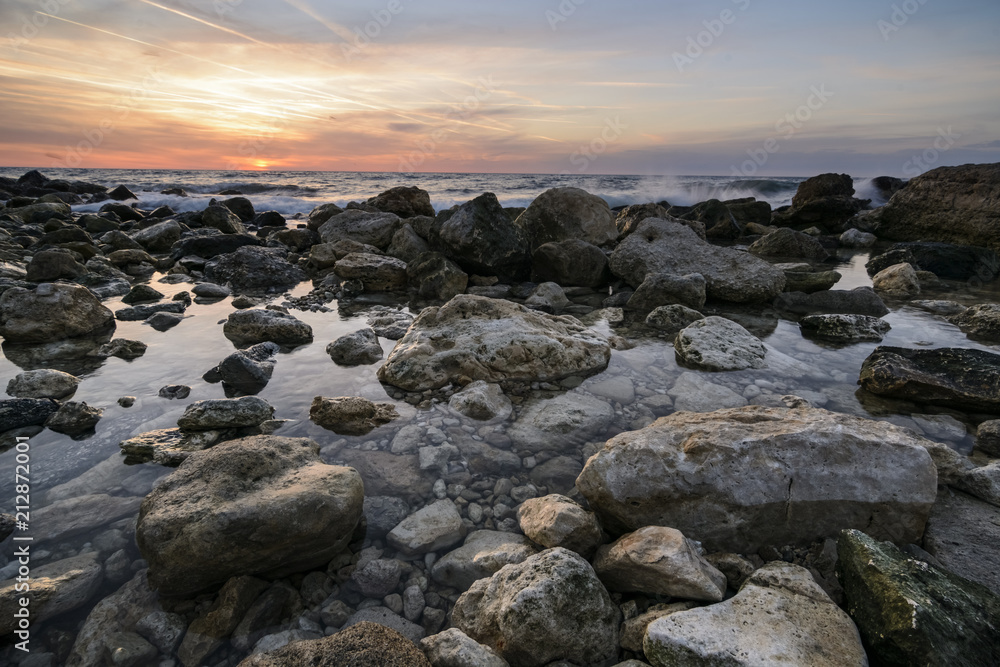 Seascape at sunrise with rocks and waves against a vibrant sky.Saint constantine and Elena beach. Seascape at sunrise with rocks and waves against a vibrant sky.Saint constantine and Elena beach.