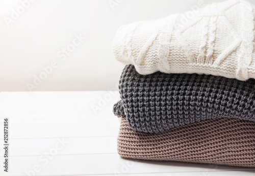 Warm knitted winter sweaters in stack