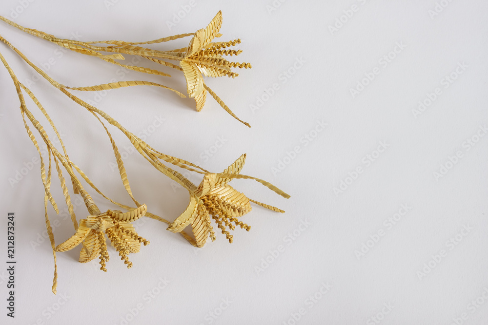 Three flowers are made of straw on a white background Three flowers are made of straw on a white background