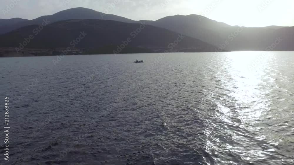 Aerial shot over the sea. Fishing boat in the horizon. Travel across islands. Aerial shot over the sea. Fishing boat in the horizon. Travel across islands.