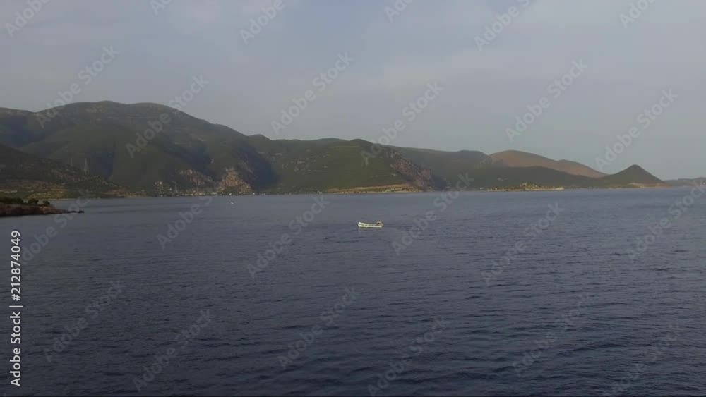 Aerial shot over the sea. Fishing boat in the horizon. Travel across islands. Aerial shot over the sea. Fishing boat in the horizon. Travel across islands.