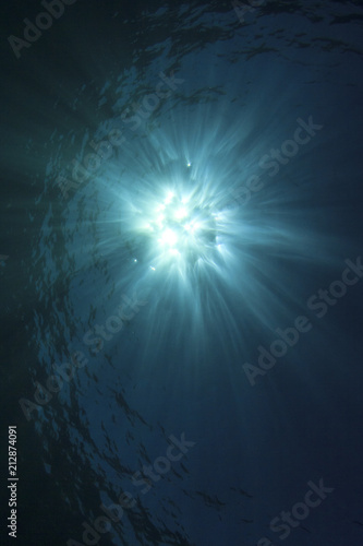 Blue sea water background and sunburst 