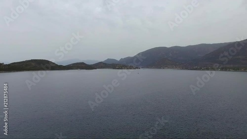 Aerial shot over the sea. Fishing boat in the horizon. Travel across islands. photo