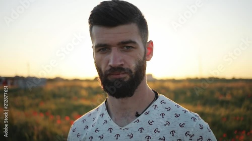 Close up portrait of smiling man standing in green wheat field on sunset and looking at camera face sky young leaf hand male summer nature school technology land beautiful sun sunlight happy sunrise