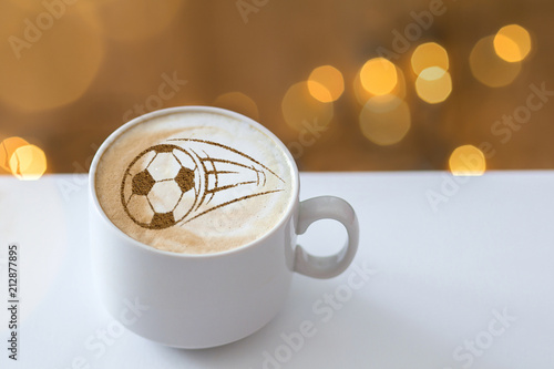 Coffee cappuccino in a cup for breakfast for a football fan