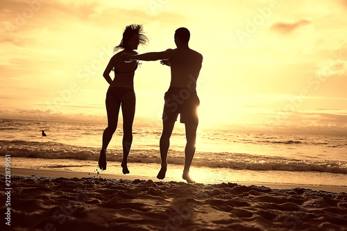silhouette in love sunset sea   newlyweds in honeymoon at sea  vacation luck summer sea beach  silhouette couple at sunset