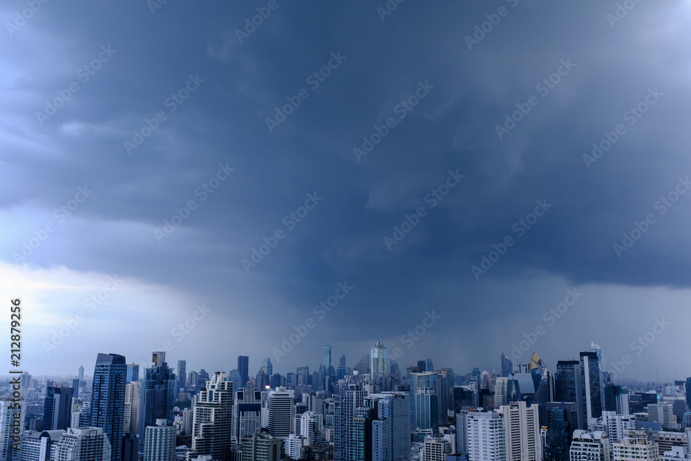 rain clouds over city, aerial cityscape, residential buildings and business skyscraper
